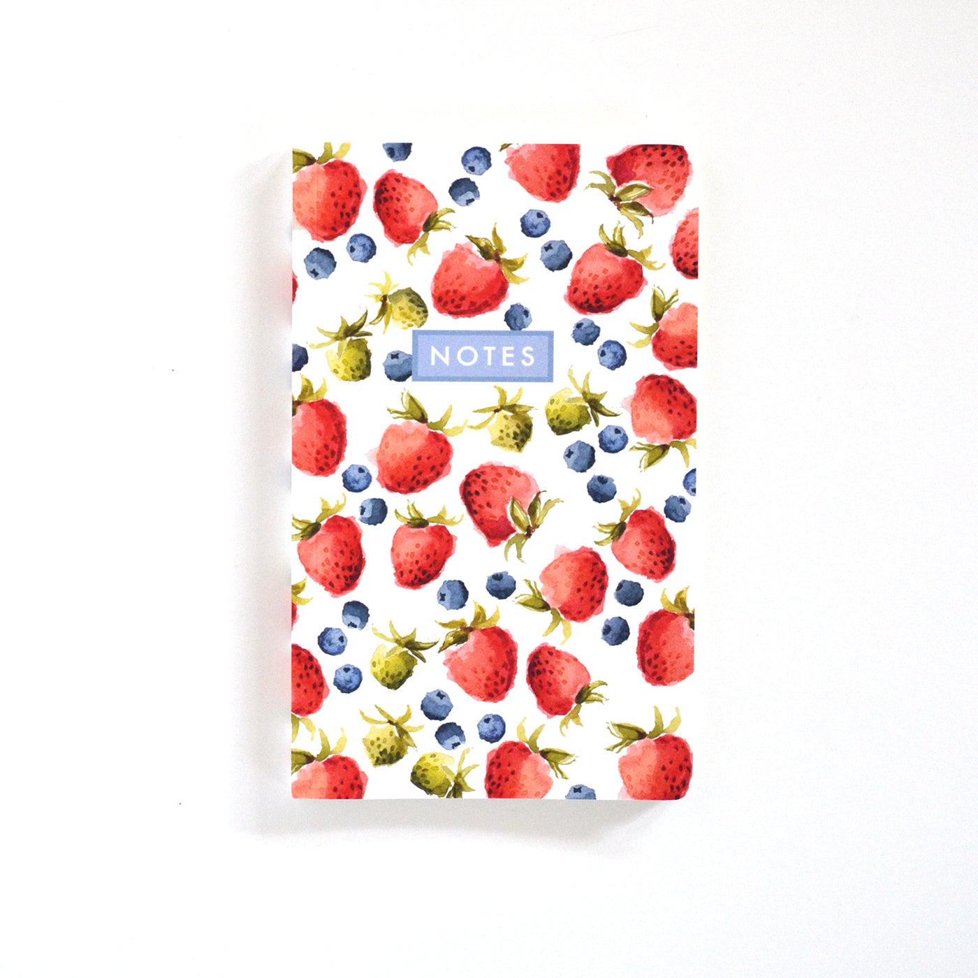 small notebook in strawberries